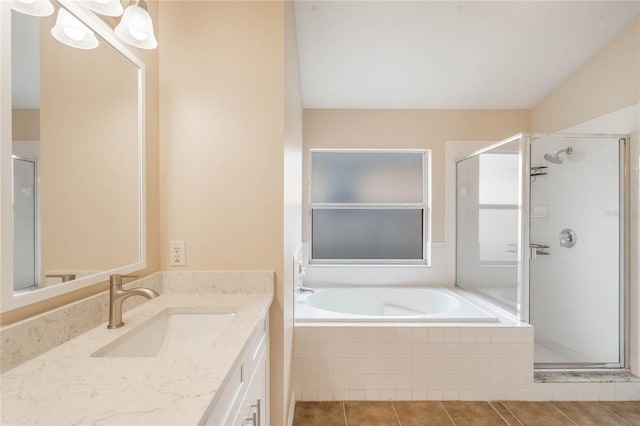 full bathroom with tile patterned floors, a shower stall, a bath, and vanity