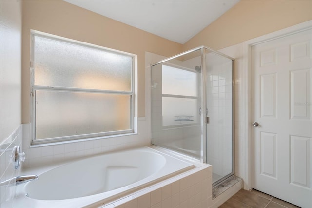 full bath featuring a stall shower, tile patterned flooring, plenty of natural light, and a bath