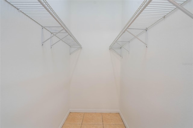 spacious closet featuring light tile patterned flooring