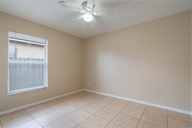 empty room featuring ceiling fan, baseboards, and light tile patterned flooring