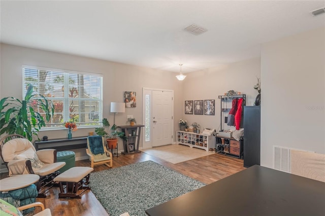 living room with visible vents and wood finished floors