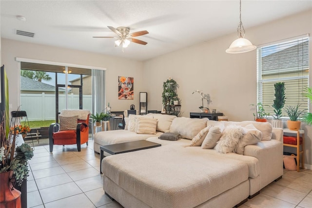 living room featuring ceiling fan, light tile patterned flooring, and visible vents