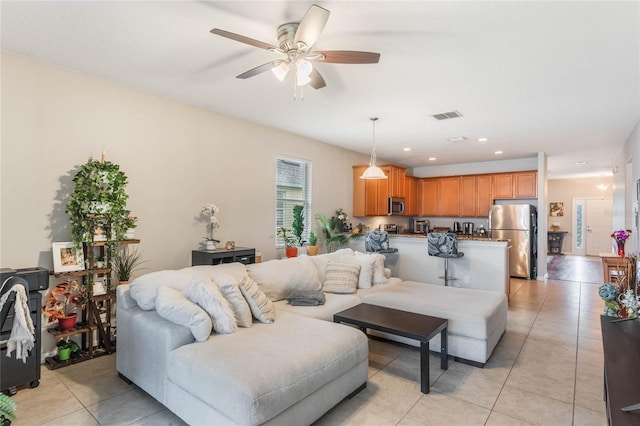 living area with light tile patterned floors, ceiling fan, visible vents, and recessed lighting