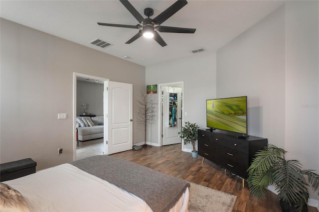 bedroom with baseboards, ceiling fan, visible vents, and dark wood-style flooring