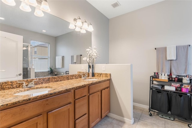 full bath with double vanity, visible vents, a sink, and tile patterned floors