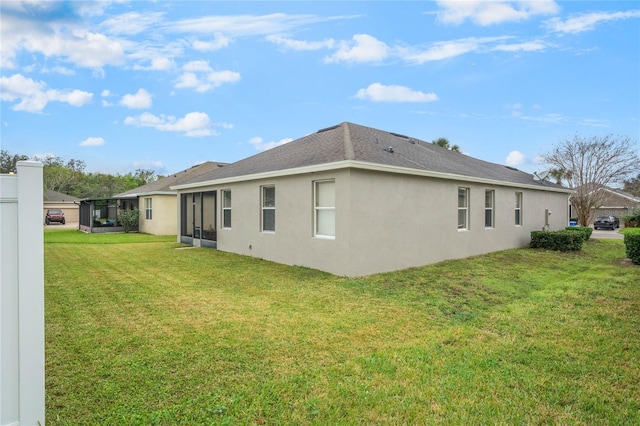 view of side of home featuring stucco siding and a yard