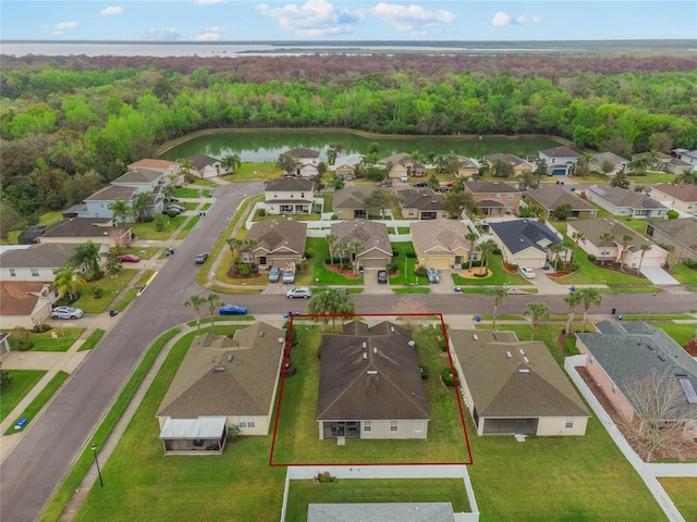 aerial view with a residential view, a water view, and a forest view