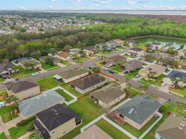 birds eye view of property featuring a water view and a residential view