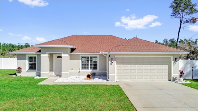 view of front of property featuring a front lawn and a garage