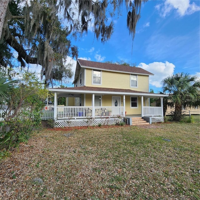 farmhouse with a front lawn and a porch