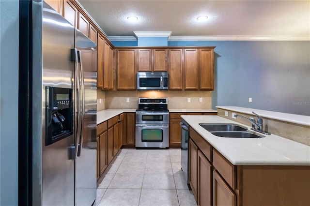 kitchen featuring sink, ornamental molding, light tile patterned floors, appliances with stainless steel finishes, and decorative backsplash