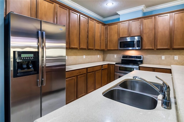 kitchen with sink, backsplash, a textured ceiling, stainless steel appliances, and ornamental molding