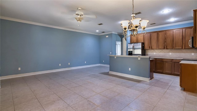 kitchen featuring tasteful backsplash, hanging light fixtures, crown molding, and stainless steel appliances