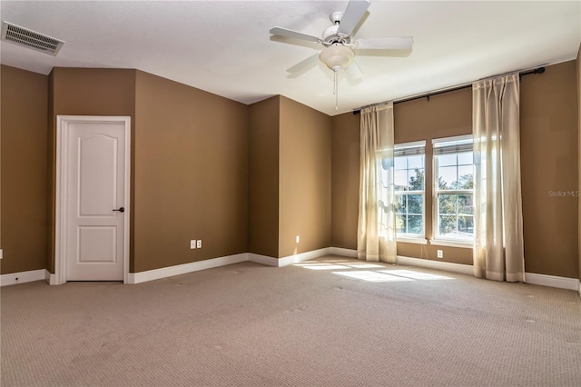 carpeted empty room featuring ceiling fan