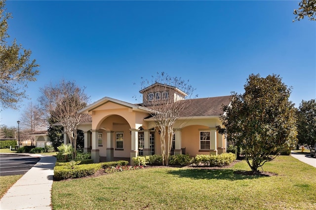 mediterranean / spanish house featuring a front lawn