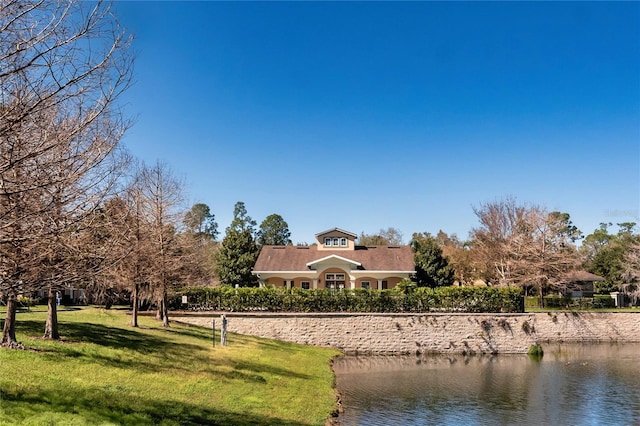 exterior space with a front yard and a water view