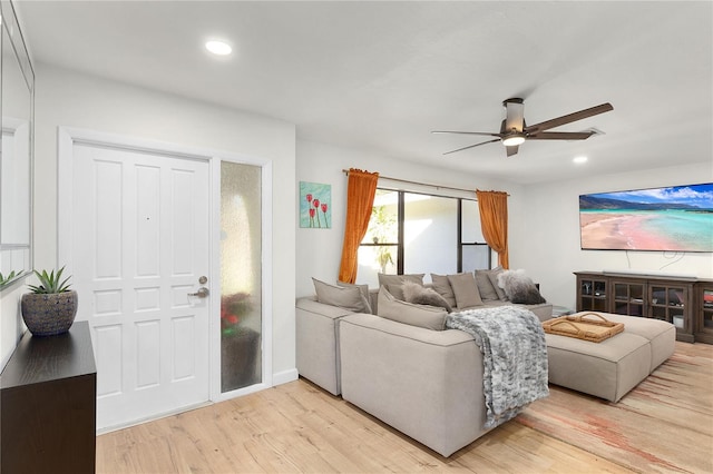 living room featuring ceiling fan and light wood-type flooring