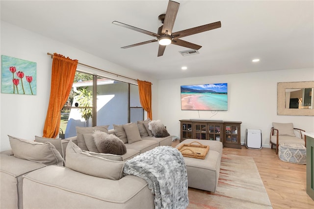 living room featuring ceiling fan and light hardwood / wood-style floors