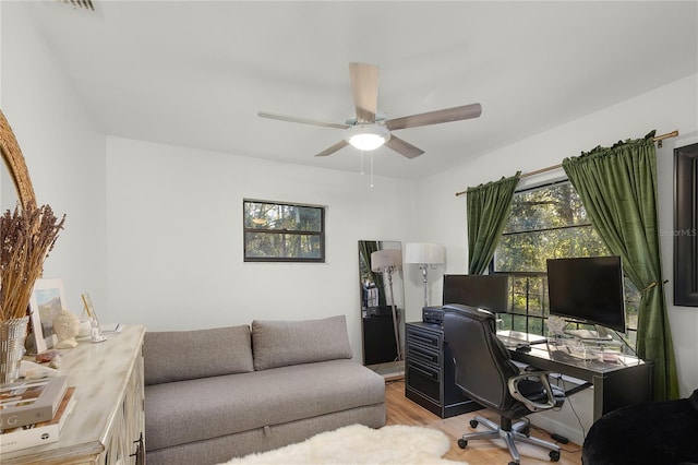 home office featuring ceiling fan and light hardwood / wood-style flooring