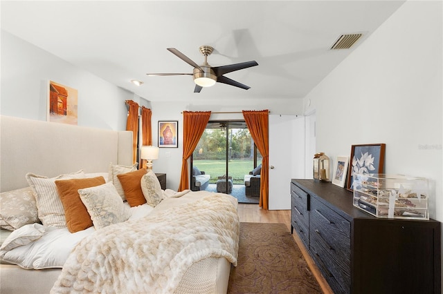 bedroom featuring access to exterior, dark wood-type flooring, and ceiling fan