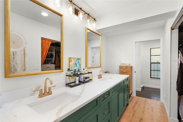 bathroom featuring hardwood / wood-style floors, vanity, and toilet