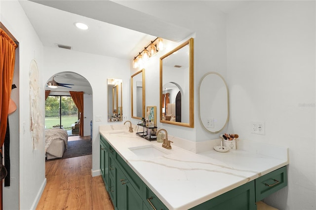 bathroom featuring hardwood / wood-style flooring, ceiling fan, and vanity