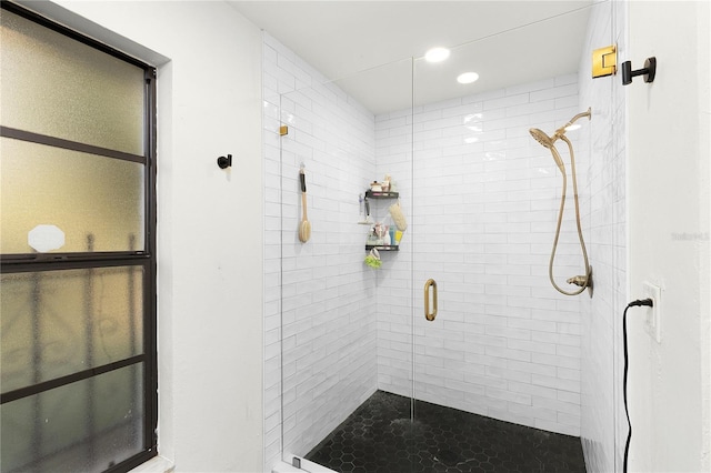 bathroom with a shower with shower door