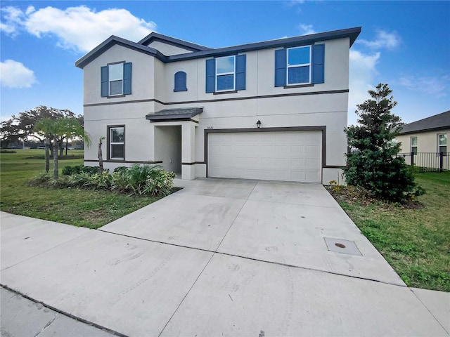 view of front of property with a front yard and a garage