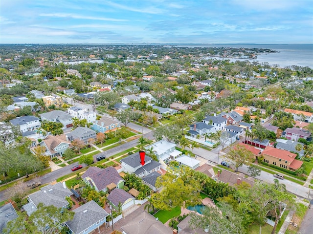 drone / aerial view featuring a residential view and a water view