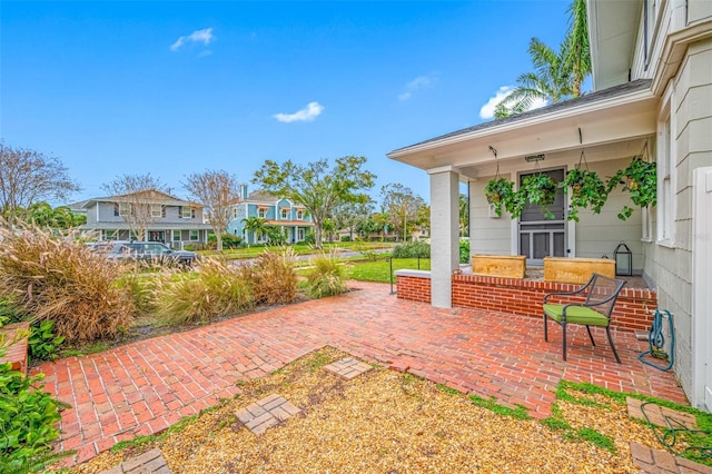 view of patio / terrace with a porch and a residential view