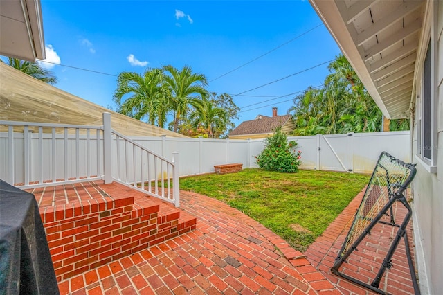 view of yard featuring a fenced backyard, a gate, and a patio