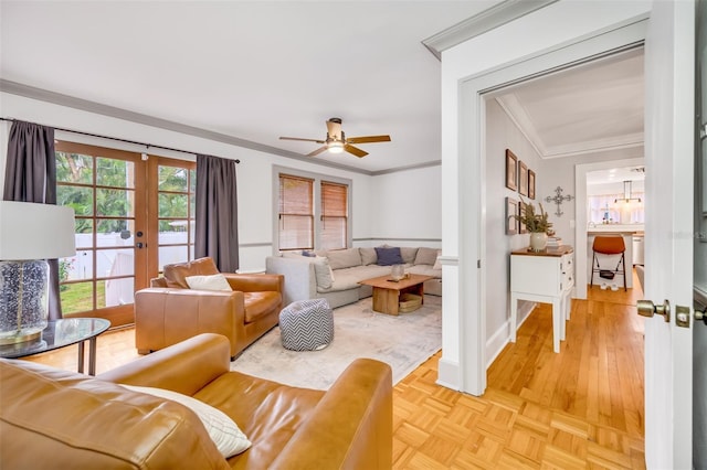 living area with baseboards, parquet floors, french doors, and crown molding