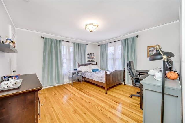 bedroom featuring crown molding and wood finished floors