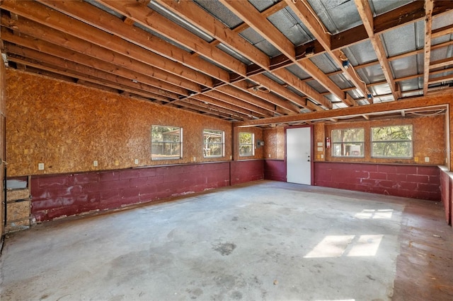 interior space featuring concrete floors and concrete block wall