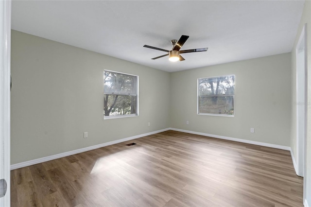 unfurnished bedroom featuring ceiling fan, baseboards, and wood finished floors