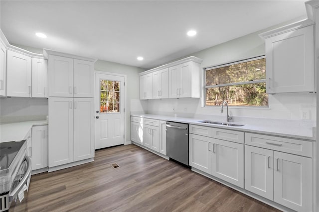 kitchen with stainless steel appliances, light countertops, white cabinetry, and a sink