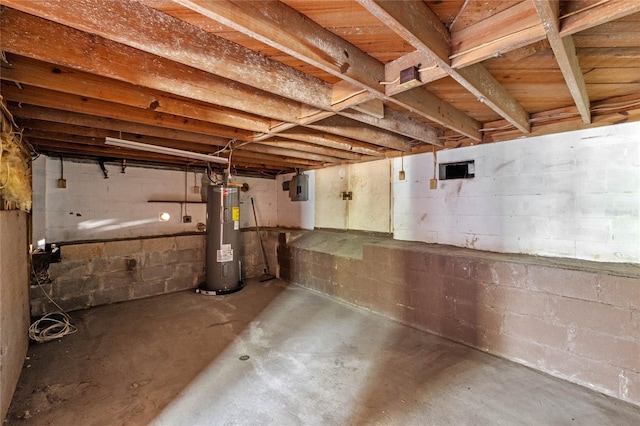 unfinished basement featuring electric panel and water heater