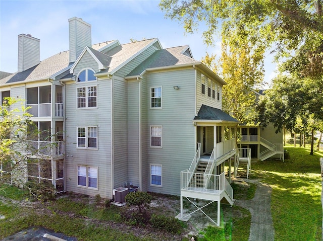 exterior space featuring central AC and a lawn