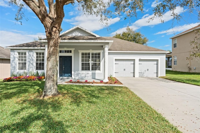 view of front of house featuring a front lawn and a garage