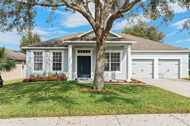 view of front of home featuring a front lawn and a garage