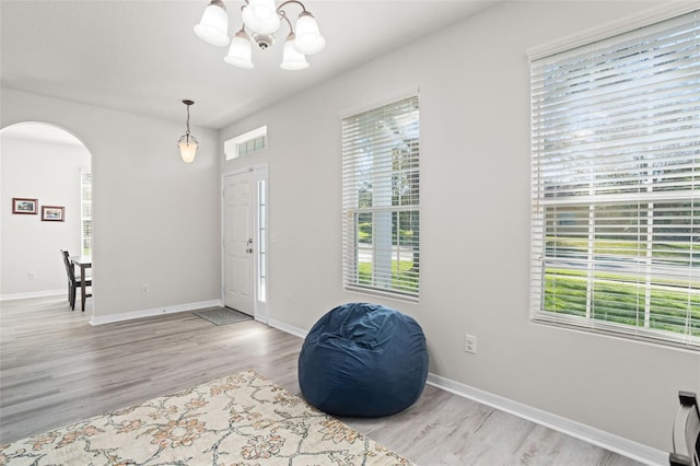 foyer featuring an inviting chandelier and light hardwood / wood-style flooring