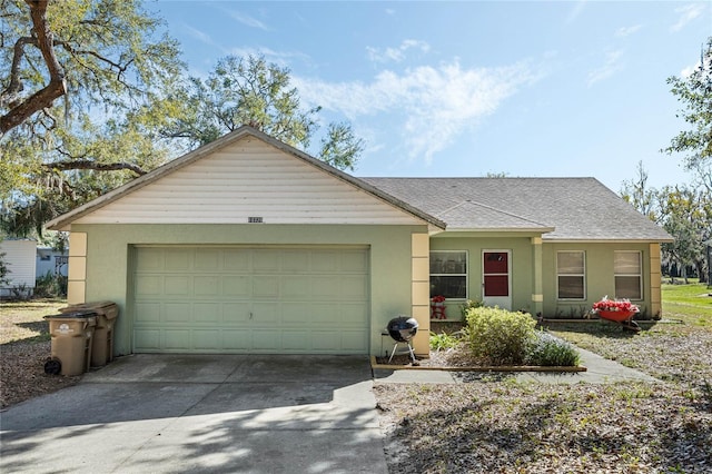 single story home featuring roof with shingles, driveway, an attached garage, and stucco siding