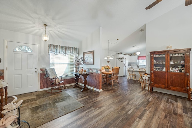 foyer entrance featuring vaulted ceiling and dark wood finished floors