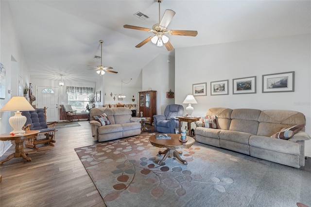 living room featuring ceiling fan, high vaulted ceiling, wood finished floors, and visible vents