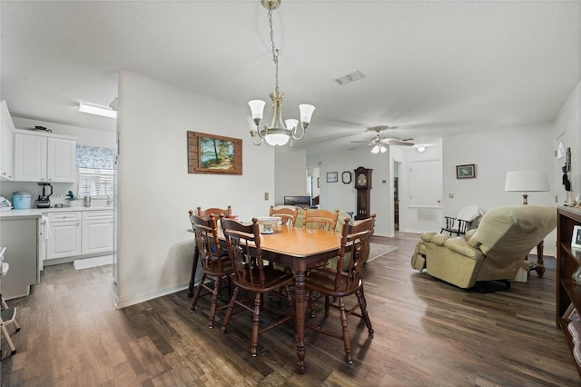 dining room with baseboards, visible vents, dark wood finished floors, and a textured ceiling