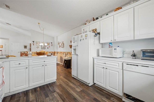 kitchen featuring light countertops, white appliances, white cabinets, and hanging light fixtures