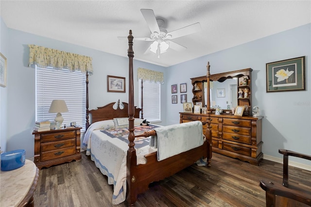 bedroom with ceiling fan, a textured ceiling, baseboards, and dark wood-style flooring