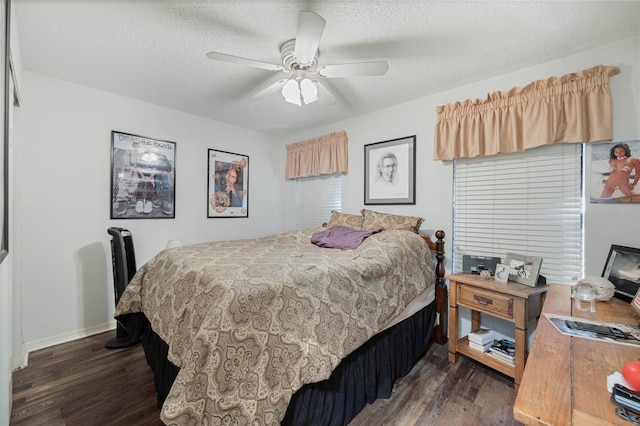 bedroom with dark wood-style floors, ceiling fan, baseboards, and a textured ceiling