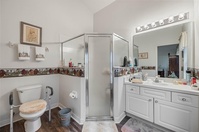 bathroom with toilet, ensuite bathroom, a stall shower, vanity, and wood finished floors