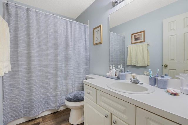 full bath with vanity, toilet, and wood finished floors